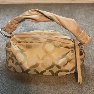 Cream colored medium-size Coach bag.